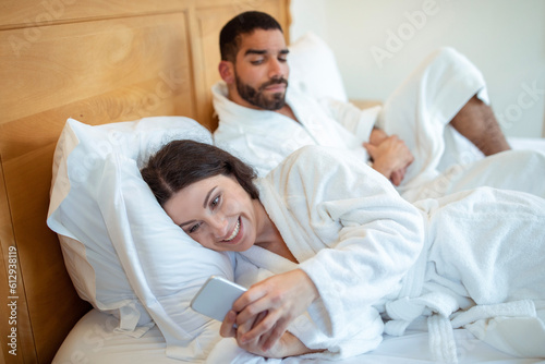 Suspicious husband seeing wife messaging on smartphone at home