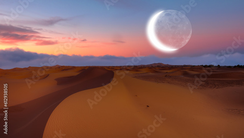 Beautiful sand dunes in orange desert at sunrise with crescent moon - Sahara  Morocco 