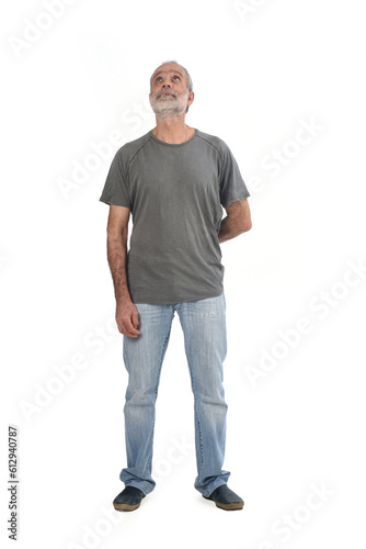 front view of middle aged man looking up on white background