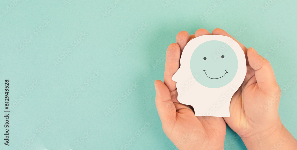 Holding a head with a happy smiling face in the hands, mental health concept, positive thinking, support and evaluation  - obrazy, fototapety, plakaty 