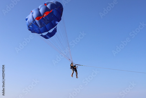 Air parachute in the sky. Water parachute, parasailing.
