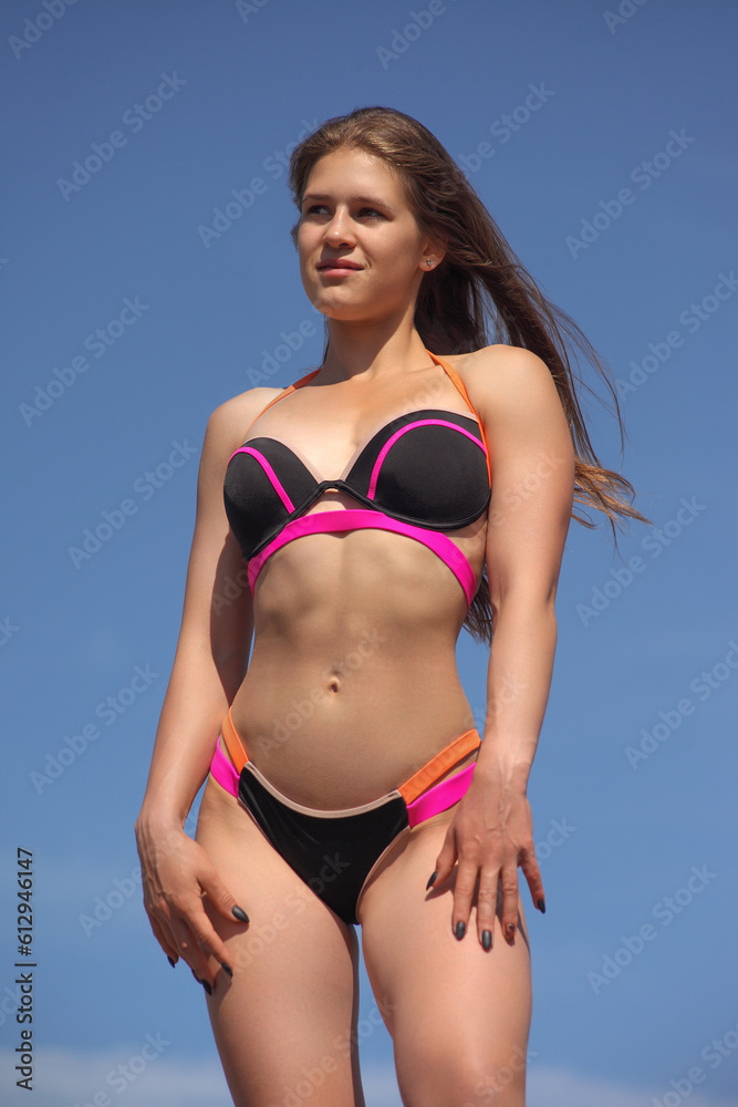 young woman with athletic figure in bikini young woman with athletic figure in bikini