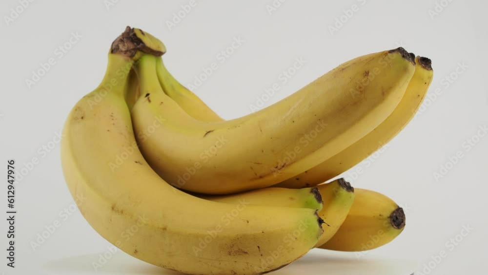 Ripe bananas rotate on a white background. Bananas close up. Ripe bananas rotate on a white background. Bananas close up.