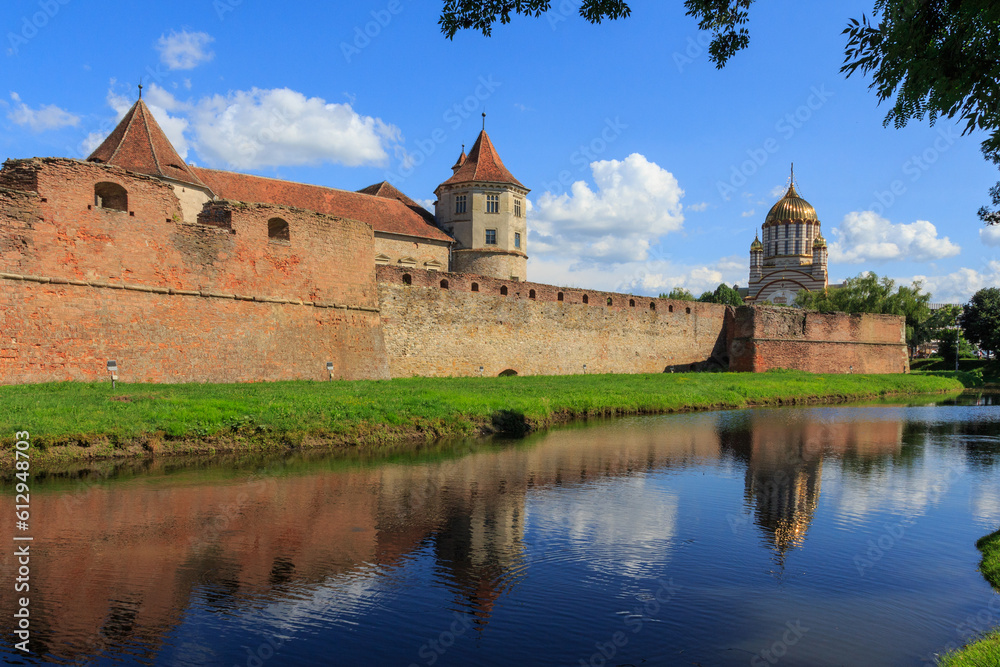 View of the Cathedral of St. John the Baptist and the historical Fagaras Fortress wall. Transylvania. Romania