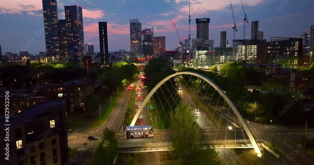 Manchester skyline aerial view during twilight filmed from Princes road and showing the new skyscrapers at Deansgate square and the traffic at the Mancunian way.