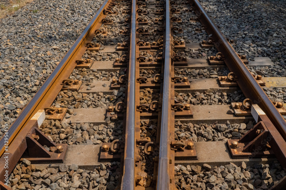 Railroads track on the industrial area with blue sky and lake. The photo is suitable to use for railroad background, railway content media and travel poster. Railroads track on the industrial area with blue sky and lake. The photo is suitable to use for railroad background, railway content media and travel poster.