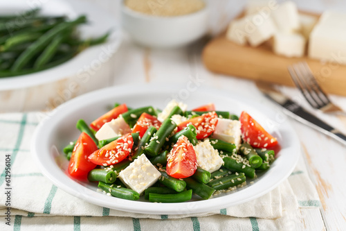 Fresh summer green beans salad bowl with tomatoes  feta  and sesame.