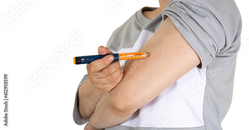 Woman doing insulin injection pen, close-up. Diabetic patient with insulin pen for control diabetes hormone therapy. Selective focus. isolated on white.