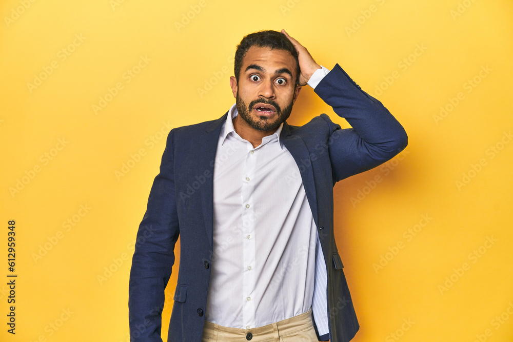 Professional young Latino man in business suit, yellow studio background, being shocked, she has remembered important meeting. Professional young Latino man in business suit, yellow studio background, being shocked, she has remembered important meeting.