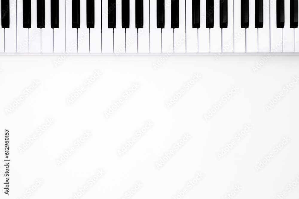 Fototapeta premium Musical keyboard on a white background, flat lay, space for text. Minimalistic music background, conceptual minimalism.
