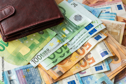 euros lying on the table, a lot of money and a wallet, financial success