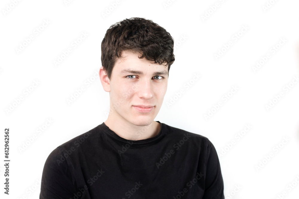 Cute shy boy teenager 18 years old on a white background in a dark T-shirt, smiling shyly. A modest young guy with a charismatic appearance, studying in college Cute shy boy teenager 18 years old on a white background in a dark T-shirt, smiling shyly. A modest young guy with a charismatic appearance, studying in college