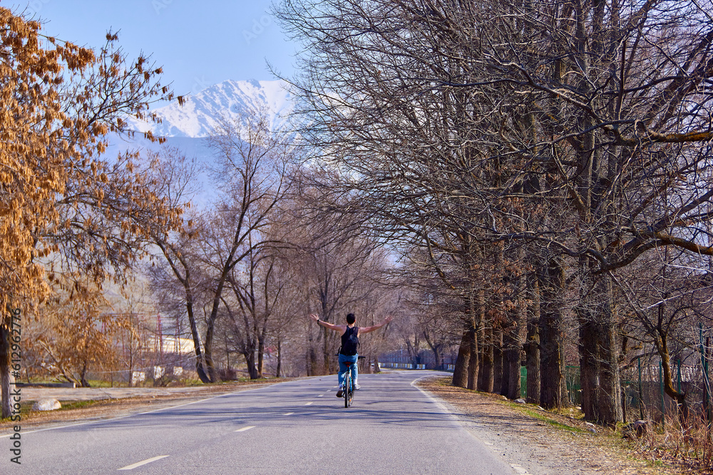 A cyclist on a bicycle goes down a mountain road. A fit and athletic man on a trip will be happy to spend time outdoors on a bicycle A cyclist on a bicycle goes down a mountain road. A fit and athletic man on a trip will be happy to spend time outdoors on a bicycle