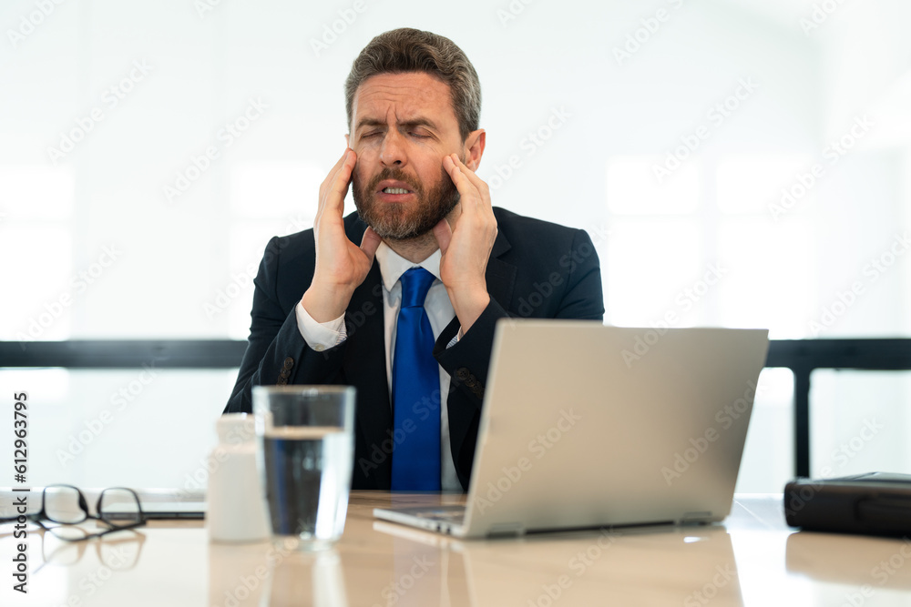 stressed business man has headache while working. stressed business man has headache pain. stressed business man has headache while working. stressed business man has headache pain.