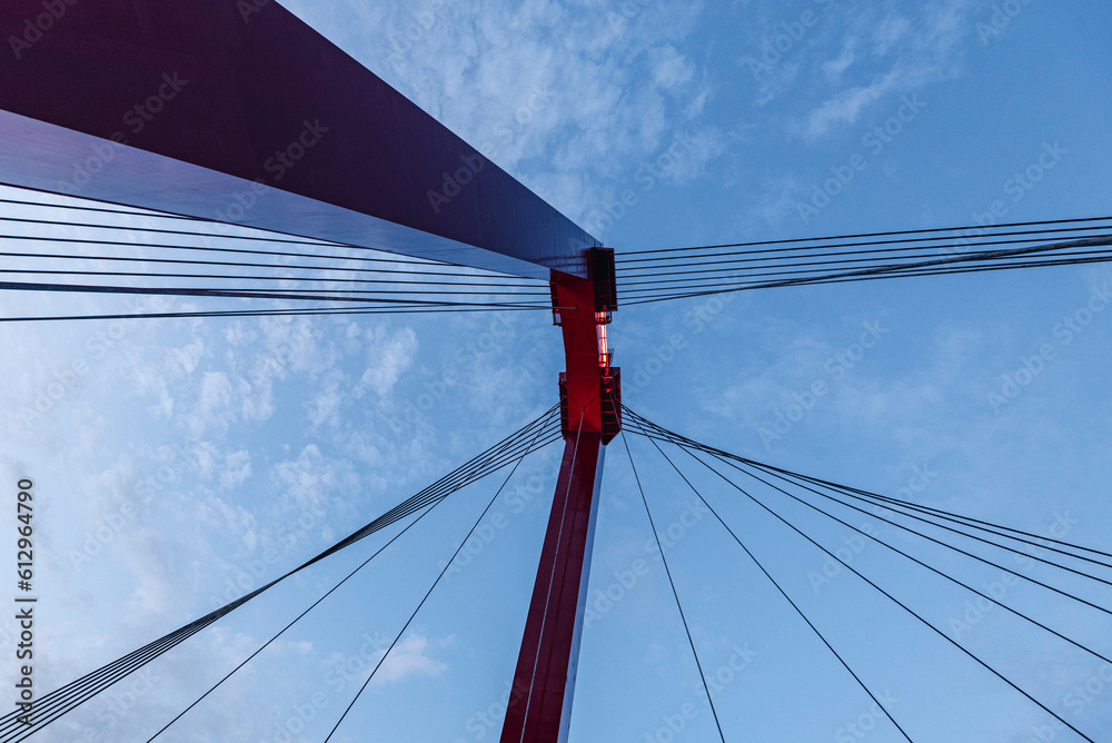 shot was taken from underneath a red bridge and blue sky shot was taken from underneath a red bridge and blue sky