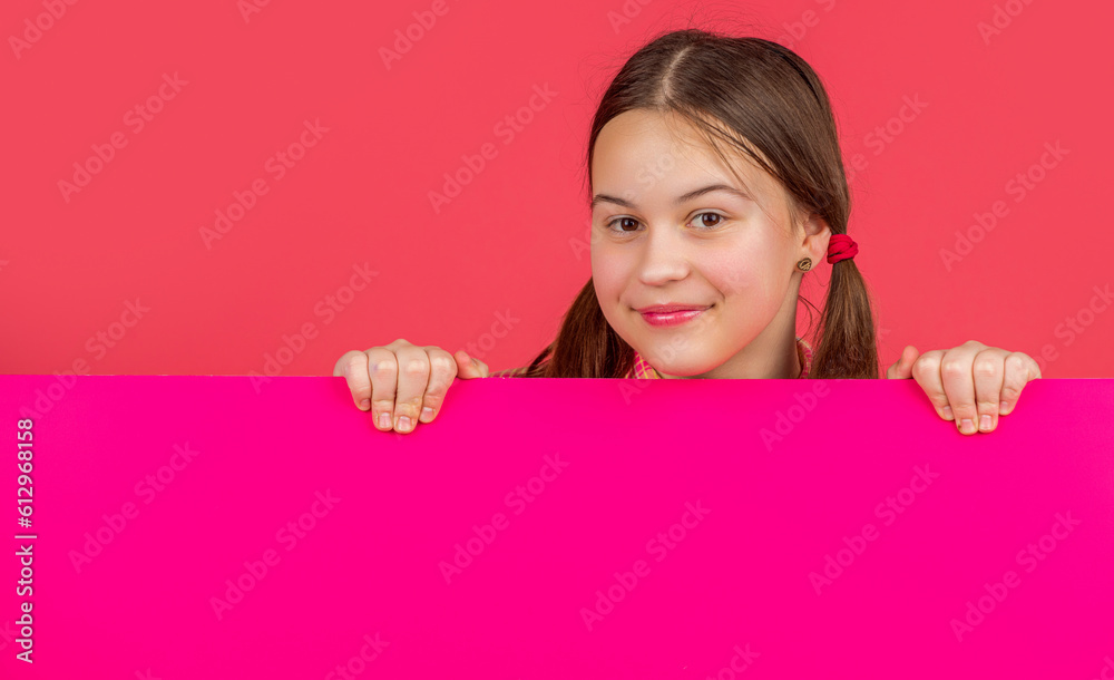 happy kid behind blank pink paper with copy space for advertisement happy kid behind blank pink paper with copy space for advertisement
