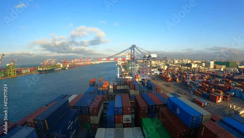 Kaohsiung, Taiwan - 02.22.2023 Time lapse of departure sailing of ultra large container vessel from Kaohsiung container terminal to next port