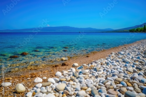 serene rocky beach with crystal clear water and majestic mountains in the backdrop. Generative AI © Lasvu