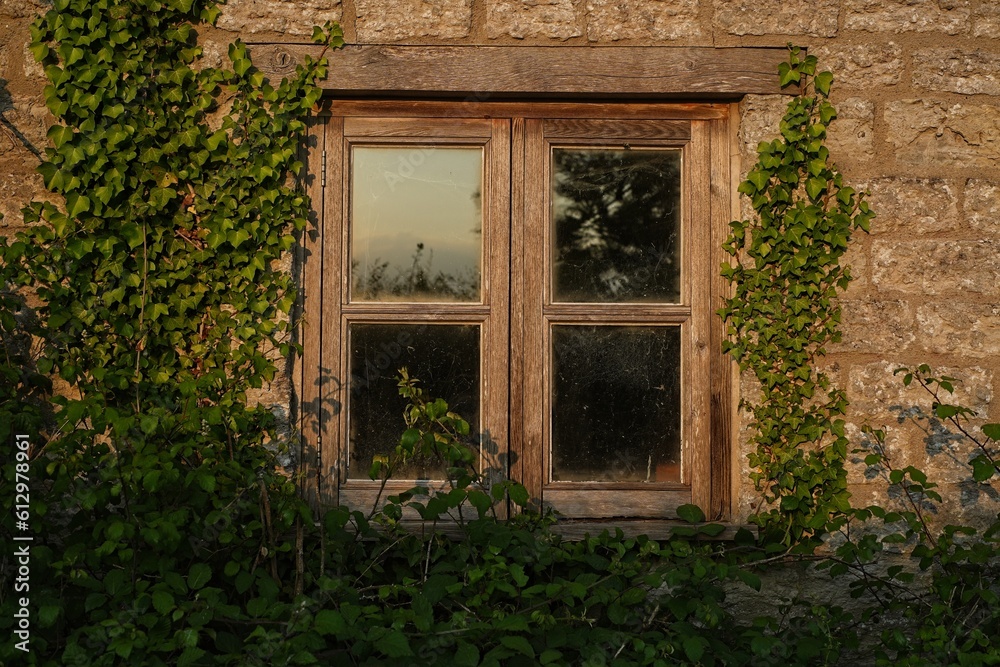 Abandoned cottage house window in the sunset light