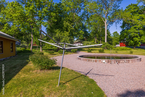 Wallpaper Mural View of metal outdoor clothes dryer on backyard on green trees background. Sweden. Torontodigital.ca
