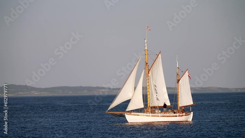 Boat Festival in Denmark Aarhus, Scandinavia, Modern sailing yacht entering old traditional scandinavian harbor, mast sailing ancient viking ship downwind close up Yachts During Summer Sailing Regatta photo