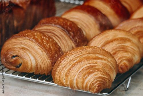 Close-up of fresh and beautiful french pastries (croissants, pains au chocolat) in a bakery showcase