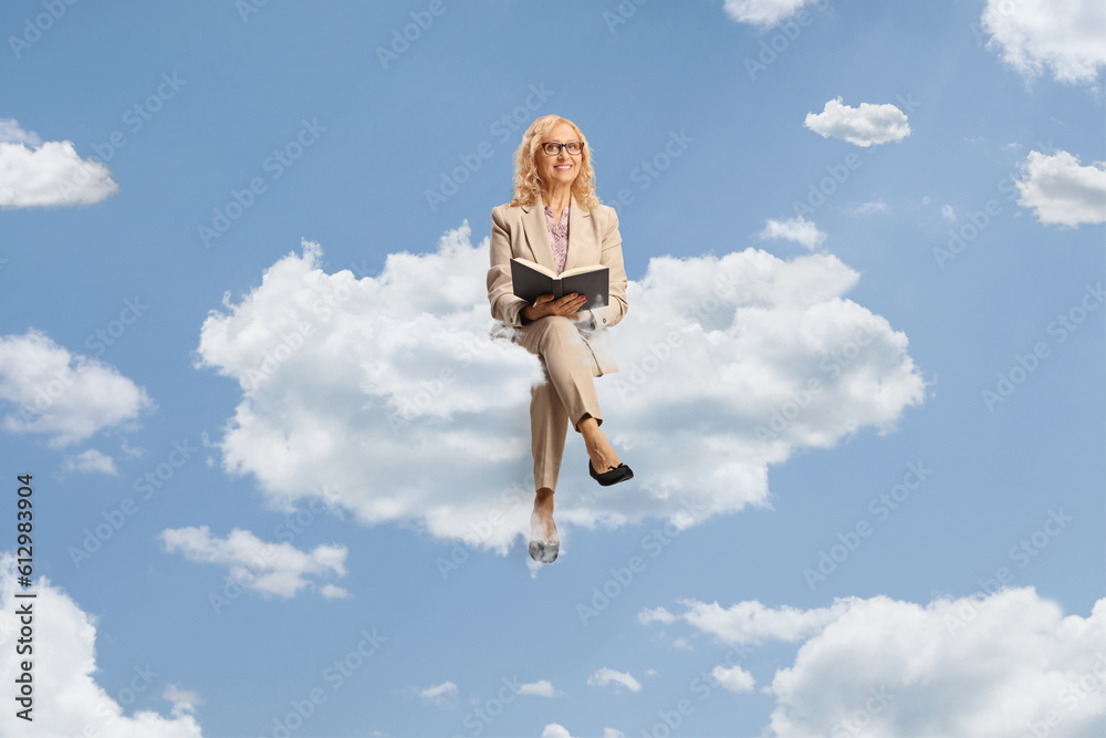 Mature woman sitting on a blank panel and reading a book Mature woman sitting on a blank panel and reading a book