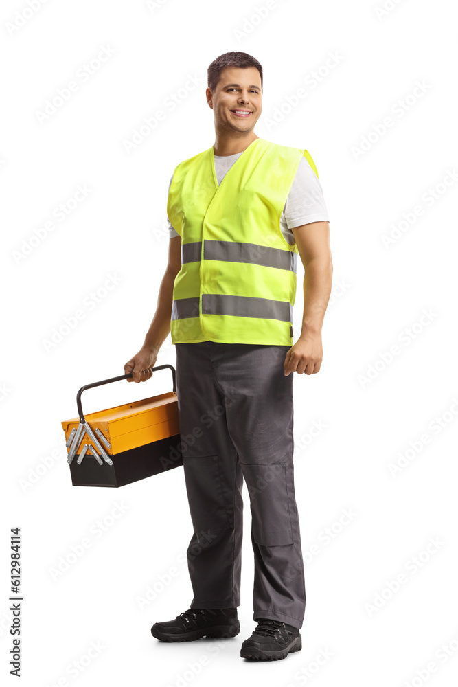 Contractor in a reflective vest holding a tool box and smiling Contractor in a reflective vest holding a tool box and smiling