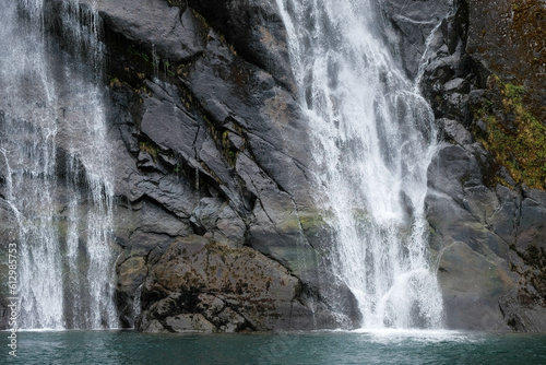Falling water and mossy stone face in Endicott Arm, Alaska, USA