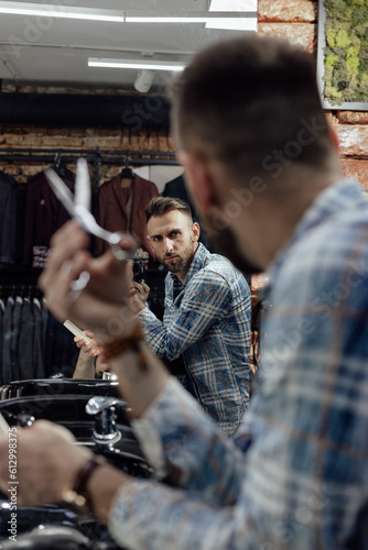 Portrait of a barber with haircut tools in barbershop
