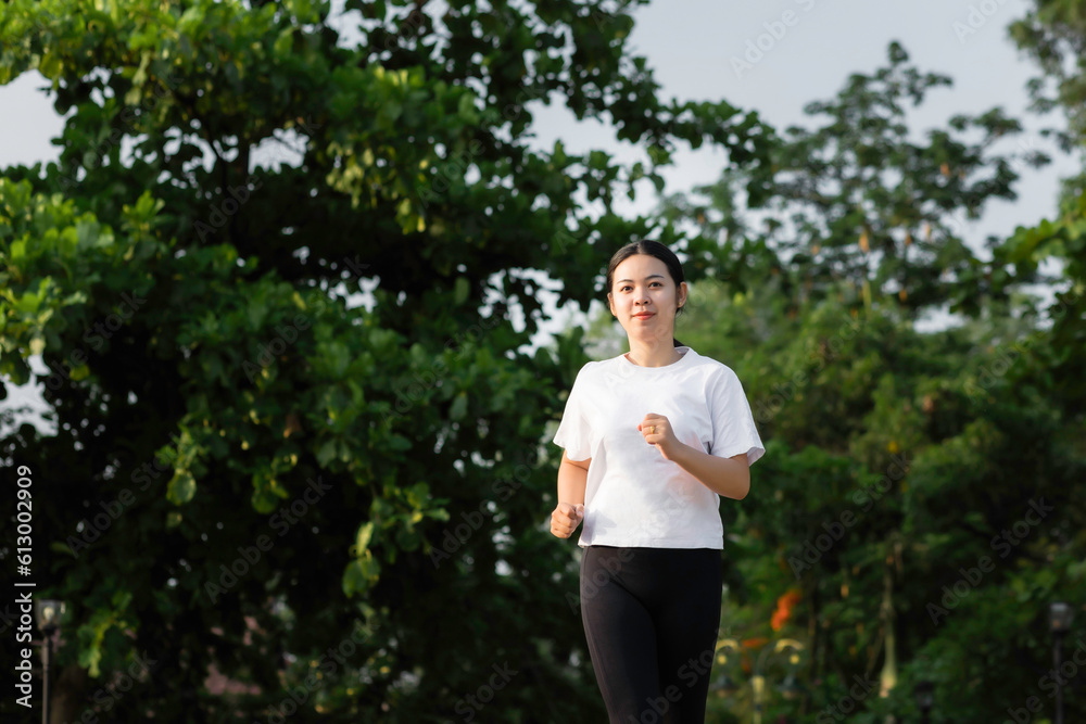 Asian young women running outdoors, healthy lifestyle, and sports concepts Asian young women running outdoors, healthy lifestyle, and sports concepts