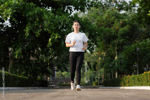 Asian young women running outdoors, healthy lifestyle, and sports concepts © Keopaserth