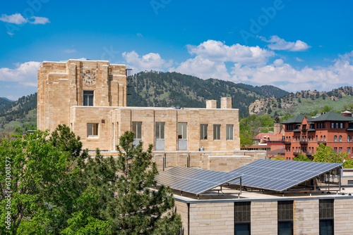 Boulder City Hall against the backdrop of the Rocky Mountains in Colorado. Solar panels on building in front.