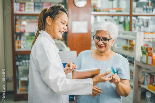 Pharmacist giving advice And advice for patients who come to buy Medicine  Drugs  Vitamins products  according to prescriptions in modern pharmacies.