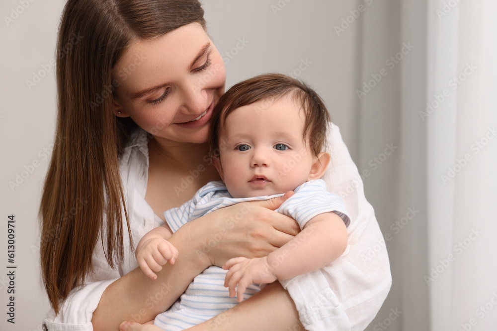 Happy mother with her little baby indoors Happy mother with her little baby indoors