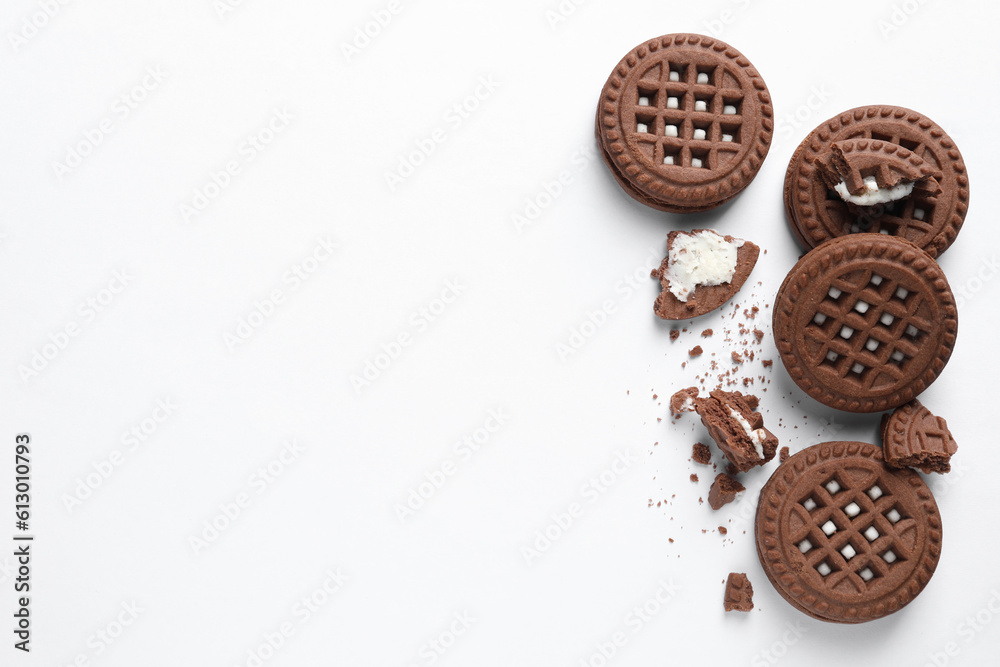Fototapeta premium Tasty sandwich cookies with cream on white background, flat lay. Space for text