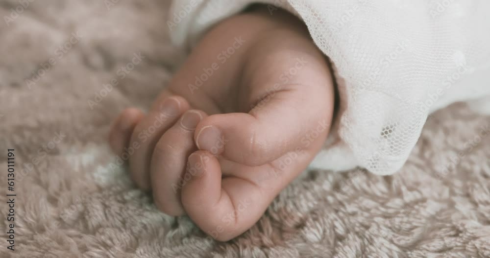 A 2x slow motion of sleeping asian baby left hand on the carpet handheld A 2x slow motion of sleeping asian baby left hand on the carpet handheld