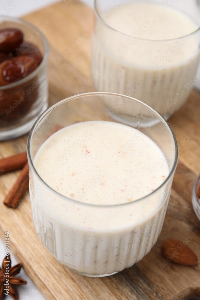 Glasses of delicious date smoothie on wooden board, closeup Glasses of delicious date smoothie on wooden board, closeup