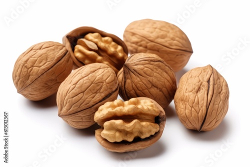 A bunch of loose and stacked walnuts with some cracked open on a white background with shadows. are photographed closely. Generated Ai.