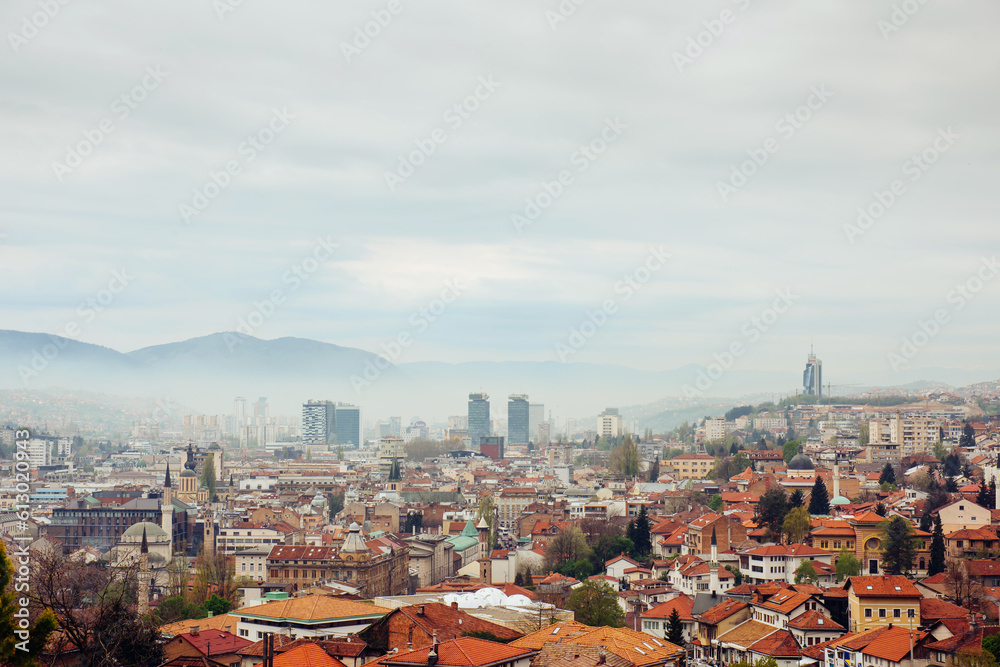 Panoramic view of the spring city of Sarajevo, Bosnia and Herzegovina. A trip to a European Balcan city in the mountains with orange roofs