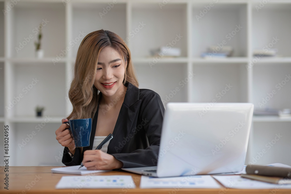 young asian woman sitting and taking note at house. Happy smiling working online, Freelance work at home young asian woman sitting and taking note at house. Happy smiling working online, Freelance work at home