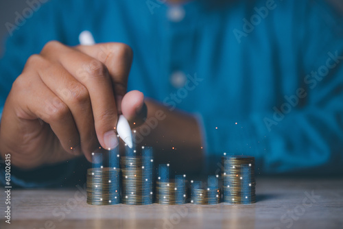 Businessman stacking coins with screen forex trading graph financial data. Goal business profit graph development. Stock market, financial growth report.