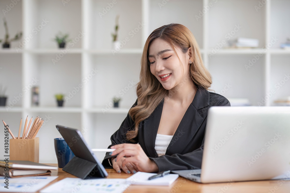 Asian Business woman using calculator and laptop for doing math finance on an office desk, tax, report, accounting, statistics, and analytical research concept Asian Business woman using calculator and laptop for doing math finance on an office desk, tax, report, accounting, statistics, and analytical research concept