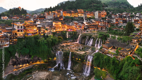 Beautiful ancient town in China with waterfall and traditional houses photo