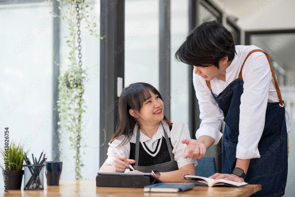 Two happy male and female university students collaborating on a project in campus. Education, Learning and technology concept