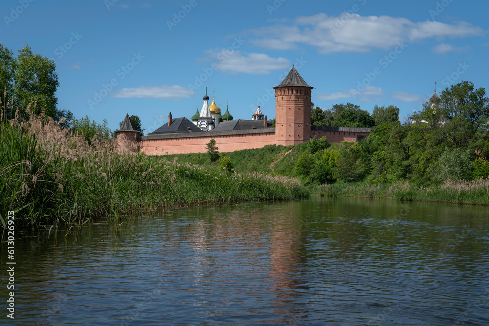 View of the Spaso-Evfimiev Monastery (a monastery of the Vladimir Diocese of the Russian Orthodox Church) on the bank of the Kamenka River on a sunny summer day, Suzdal, Vladimir region, Russia