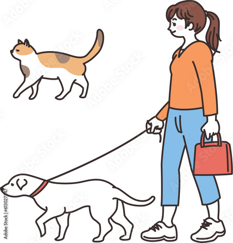 犬と散歩する若い女性　野良猫