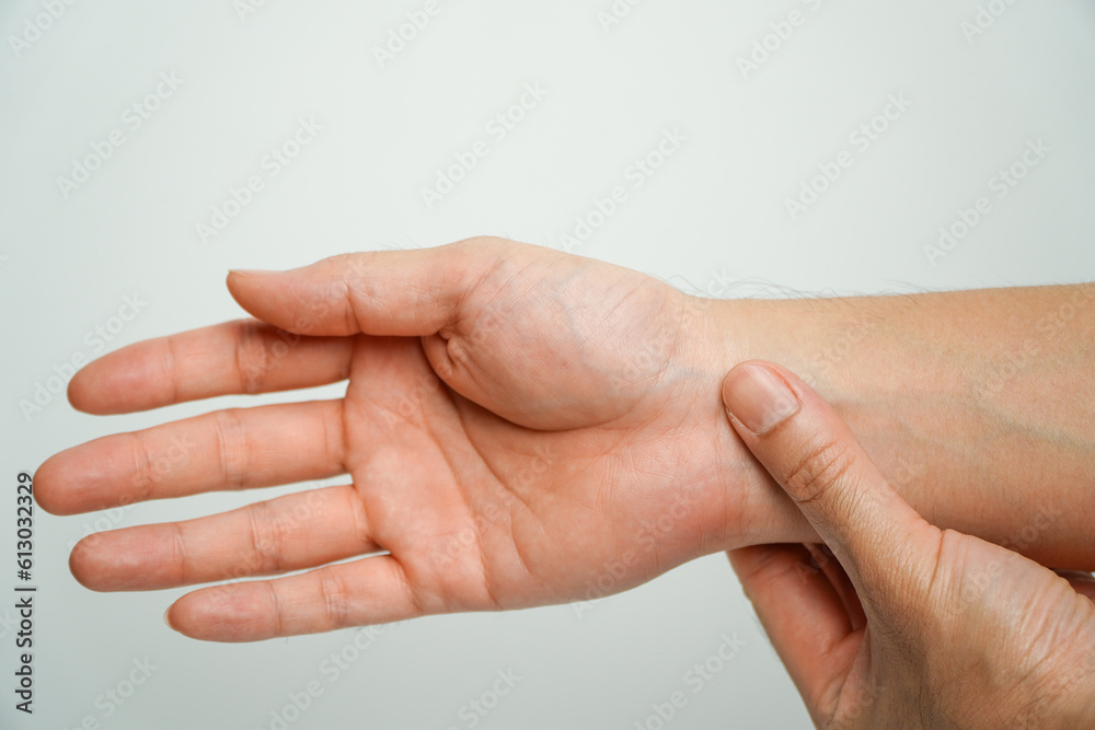 health care concept. Asian man holding his wrist with office syndrome, Pain in the joints of the hands. Carpal tunnel syndrome. health care concept. Asian man holding his wrist with office syndrome, Pain in the joints of the hands. Carpal tunnel syndrome.