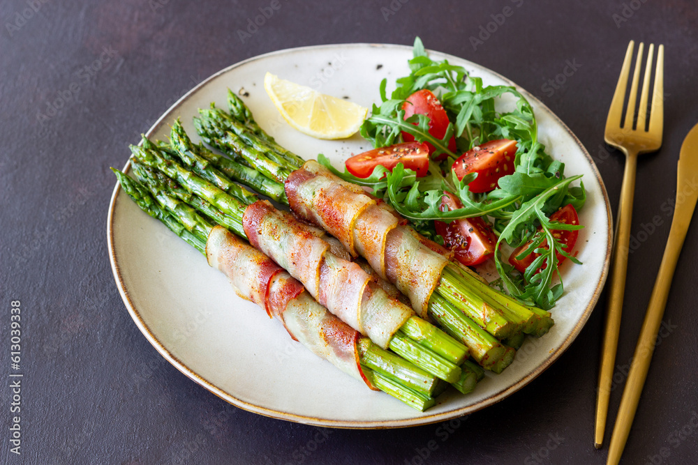 Asparagus baked with bacon and arugula and tomato salad. Healthy eating. Diet. Asparagus baked with bacon and arugula and tomato salad. Healthy eating. Diet.