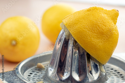 Half lemon on a hand juicer photo